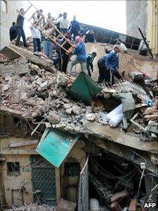 Rescue workers search a collapsed building in Alexandria, Egypt, 12 December 2010