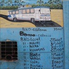 A picture of a bus and timetable on a wall, West Africa, 2010