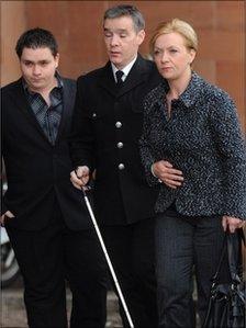 Pc David Rathband arrives at court with his wife and son