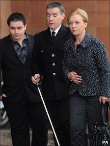 Pc David Rathband arriving in court with his wife and son earlier in the trial