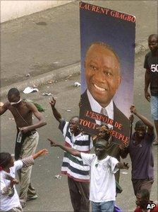 Supporters holding a poster of Laurent Gbagbo in 2000