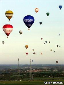 A group of air balloons head for France after taking off from Kent during a world record-breaking attempt for the largest number of hot air balloons to cross the English Channel