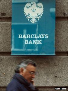 A man walks past Barclays Spain sign in Madrid