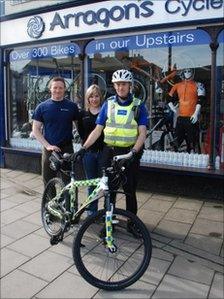 PCSO Tony Labram with Phil and Sarah Graham of Arragon's Cycles and one of the new bicycles