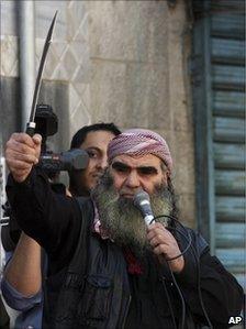 A Salafist protester holds a sword during a demonstration in Zarqa, east of Amman, 15 April