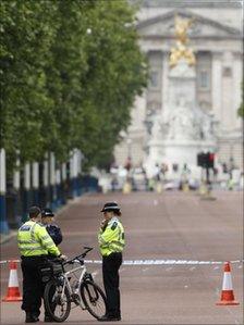 Police man a cordon on the Mall outside Buckingham Palace