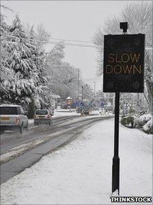 Slow down sign in snow (Thinkstock)