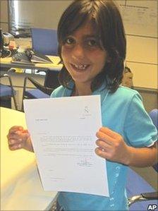 In this undated photo released by the Coira family, Leonel Angel Coira shows the contract he signed with Real Madrid at their headquarters in Madrid, Spain