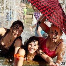 Charlotte Wilford, Hannah Young and Laura Allen enjoy the warm weather in a fountain in the centre of Sheffield