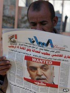 An Iraqi man in Baghdad reads a local newspaper, featuring a front page picture of Vice-President Tareq al-Hashemi with the word "wanted" above his face, on December 20, 2011.