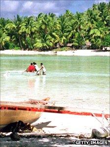 Men cross a lagoon on a boat