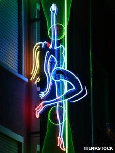 Neon sign advertising a pole dancing club