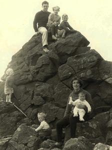 Mark and his father atop a rock in Arran with family friends