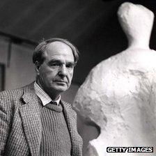 Henry Moore standing by one of his sculptures in 1960
