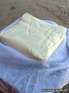 Curds resting on a wet cheesecloth