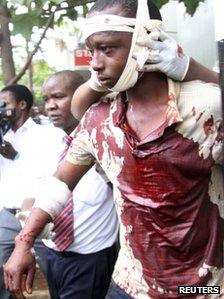 A man injured during an explosion is assisted from the scene in Kenya"s capital Nairobi, May 28, 2012.