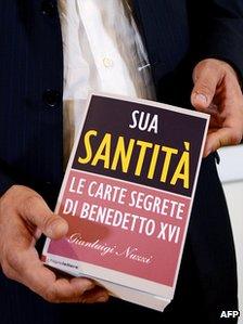 Italian journalist Gianluigi Nuzzi holds his book "Sua Santita, le carte segrete di Benedetto XVI" ("His Holiness, the secrets papers of Benedict XVI"