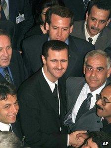 Bashar al-Assad shakes hands with Baath Party members before being elected chairman of its Regional Command in 2000