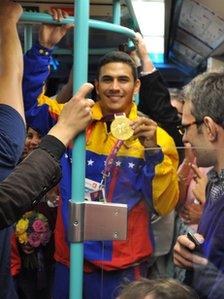 Ruben Limardo shows off gold medal on the DLR, 2 August 2012, pic courtesy of Chris Scanlan
