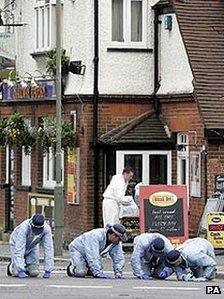Police forensics team searching outside The Railway Tavern in Edgware