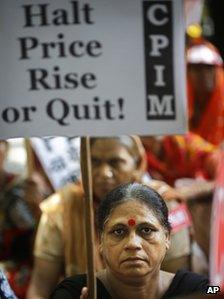 A supporter of Communist Party of India (Marxist) holds a placard in a protest in New Delhi, India,Thursday, Sept. 20, 2012.