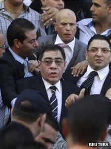 The chief prosecutor of Egypt, Abdel Maguid Mahmoud, surrounded by supporters, 13 October