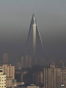 The Ryugyong Hotel stand above the smog dominating the Pyongyang skyline in 2011