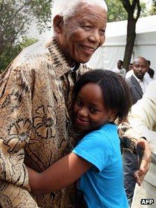 Nelson and Zenani Mandela hug in Soweto, South Africa, file photo from December 2008