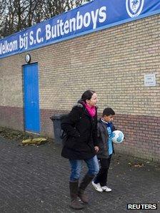 A young player of the soccer club Buitenboys arrives at the clubhouse in Almere December 4, 2012.