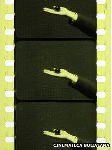 Roll of film showing someone holding a black ball