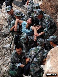 Soldiers in Sichuan, China, rescue an injured woman, 20 April
