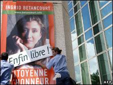 A poster in France of Ingrid Betancourt is covered over with a sign "Free at last"