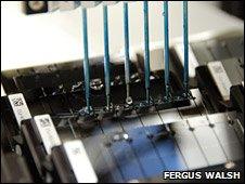 DNA samples being washed over silicon slides