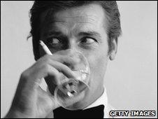 James Bond actor Roger Moore with a drink and a cigarette