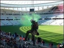 A member of the Police Tactical Response Unit abseils in the Green Point Soccer Stadium, as he take part in a simulated exercise in the Soccer World Cup host city of Cape Town, South Africa, Thursday, April 29, 2010.
