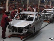 Chinese workers assemble cars at an auto plant in Hefei, central China's Anhui province