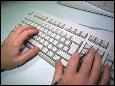 A user types on a computer keyboard