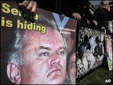 Demonstrators at the Hague hold posters accusing Serbia of hiding Ratko Mladic - 13 April 2010