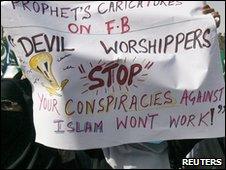 Women supporters of Islamic political party Jamaat-e-Islami hold a placard during a protest against Facebook in Karachi May 19, 2010.