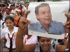 A supporter holds up a photo of Juan Manuel santos during a rally in northern Colombia on 20 May