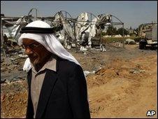 A man walks past bombed out camp in Beit Hanoun