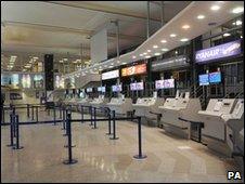 Empty check-in desks at Manchester Airport
