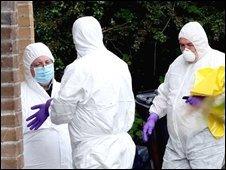 Forensic scientists examine scene