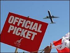 Striking BA workers wave banners at Heathrow
