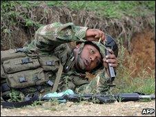 A soldier reloads his rifle during a gunfight with Farc rebels in Corinto in the department of Cauca on 30 May