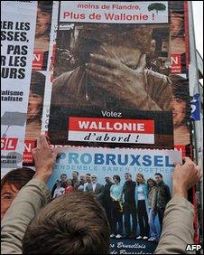 Man putting up election posters in Brussels, 1 June 2010