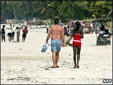 Man and girl on beach, file image