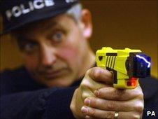 Policeman demonstrates using a Taser stun gun