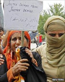 A policewoman (right) detains a woman during a protest in Srinagar on June 7, 2010
