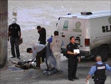 Mexican police stand near the body of Sergio Adrian Hernandez